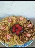 Immagine del passaggio 11 della ricetta Pancake agli agrumi, gocce di cioccolato e fragola