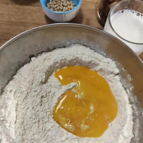 Immagine dello step: Setacciare la farina e mescolarla con lo zucchero e un pizzico di sale. Incorporare, mescolando, le uova, il rum, e il lievito con tutta l’acqua.