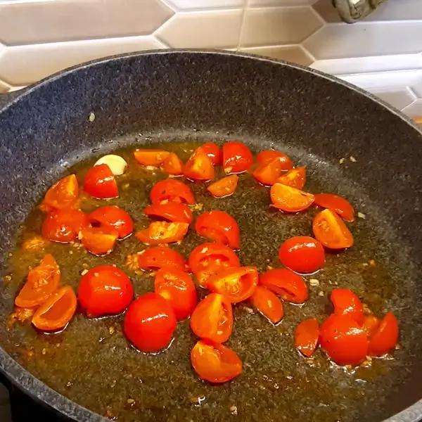 Immagine dello step: Olio in padella, aggiungi l'aglio e lascia rosolare per 2/3 minuti. Poi aggiungi i pomodorini dopo qualche minuto aggiungi un po' di acqua di cottura (5min a fiamma media)