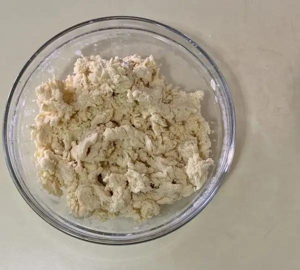 Immagine dello step: Inserire tutta la farina in planetaria con il 60% dell’acqua della ricetta (385 ml) e impasta x 3 min fino ad ottenere un composto spezzettato